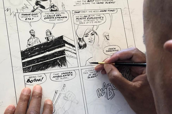 artist inking comic book page
