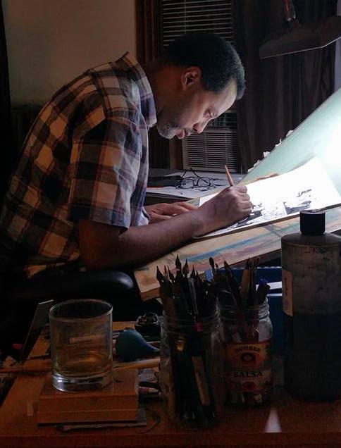 David Marshall drawing a comic book